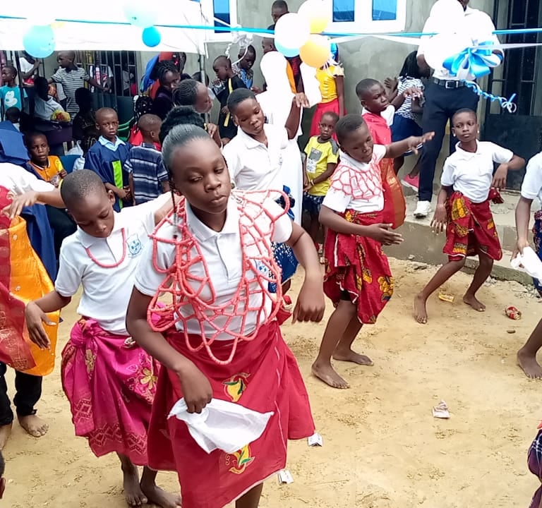 Students performing traditional dance during school celebration