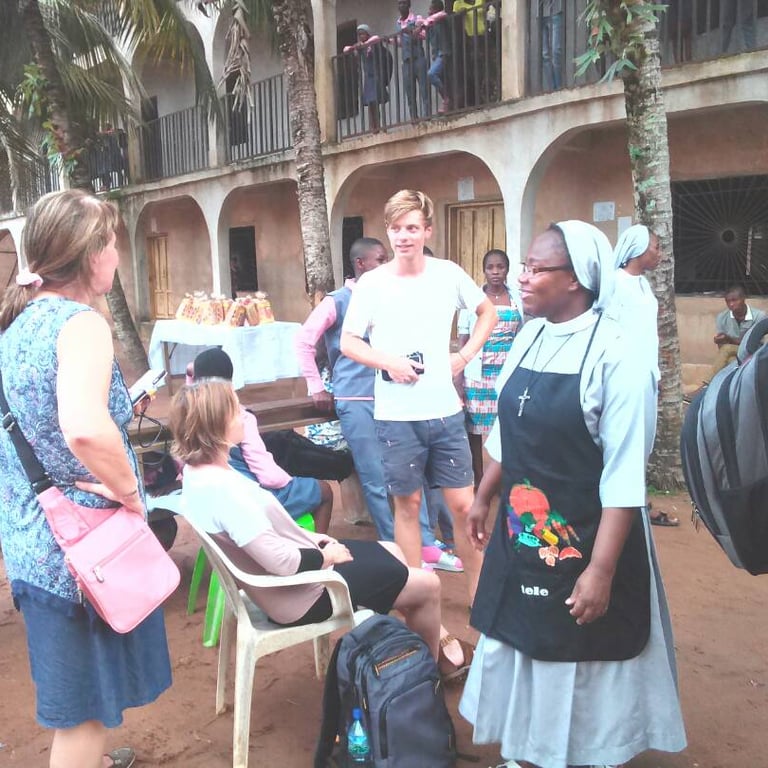Missionary sisters speaking with community members during outreach event