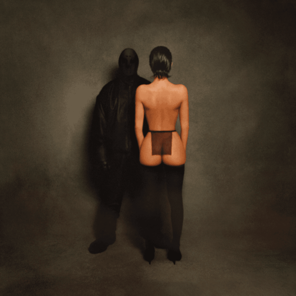 a man in all black facing forward next to a naked woman turned around