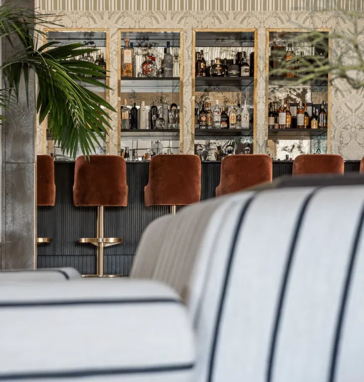 Cocktail bar at Villa La Gratitud with custom cabinetry and velvet seating