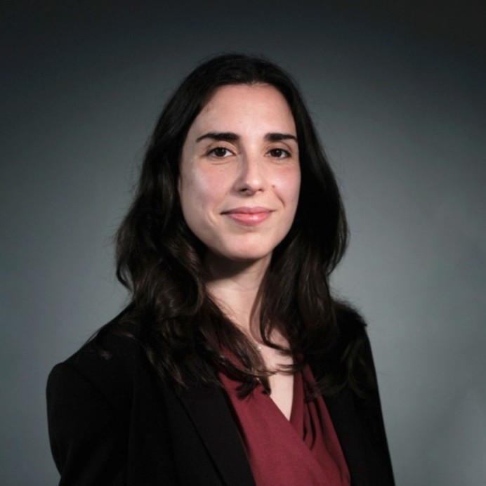 a woman in a black jacket and red shirt (Rita Gomes)