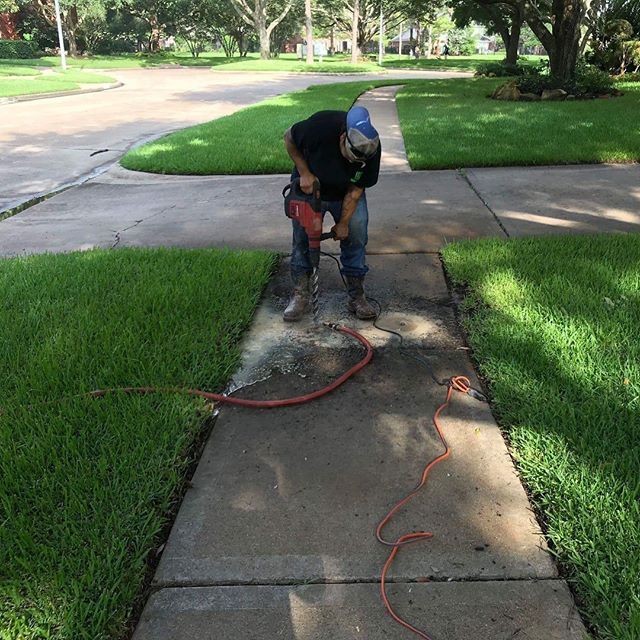 a man in a helmet is using a power drill