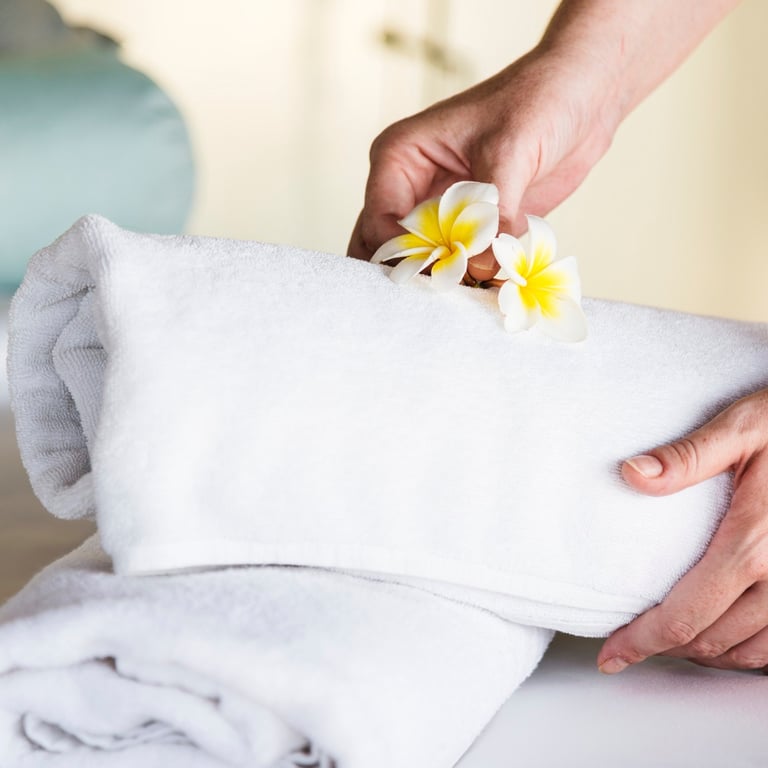a person holding a towel over a towel