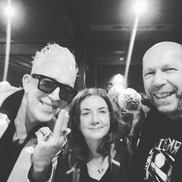 jennie lynch and her band a woman posing for a photo with two males