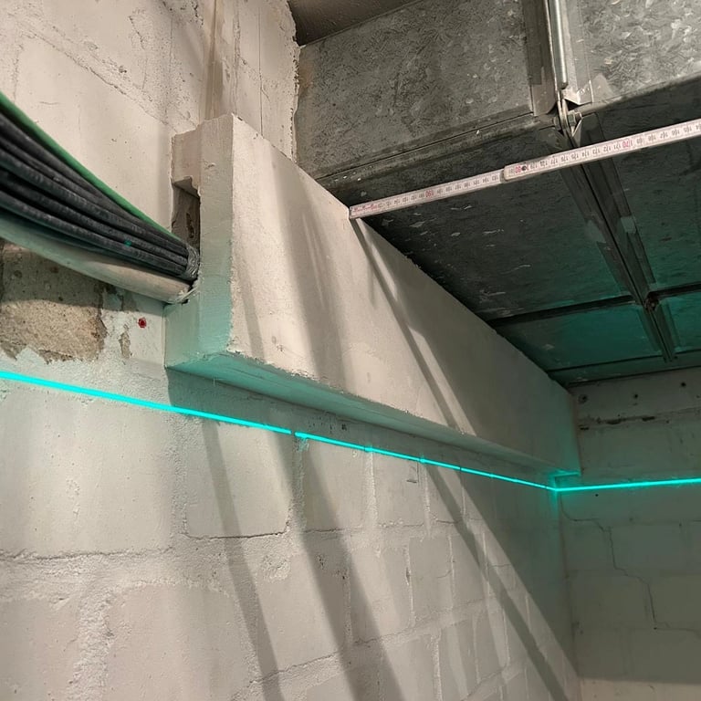 Zabudowa przeciwogniowa kanału wentylacyjnego w pomieszczeniu technicznym, płyty ognioodporne i widoczne przewody.