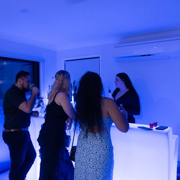 Guests at Carly and Kahn's vow renewal being served at the glow bar in Redland Bay.