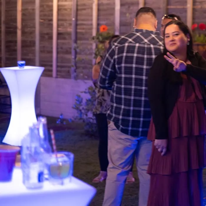 Guests mingling with glowing cocktail bars in the back yard of a vow renewal, Redlands.