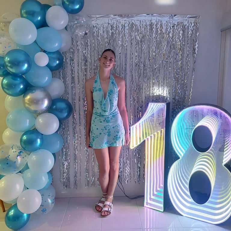 Infinity Number 18 lighting up the photo wall at an 18th Party in Thornlands, Redlands - party hire by SweetAz Co.