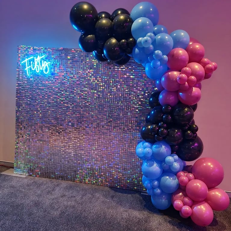 Irididescent shimmer wall and fifty neon with balloons for Mary's 50th birthday in Redlands.