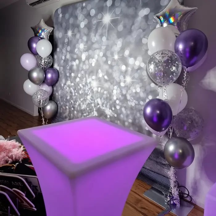 Glow cocktail table with the diamond dust backdrop for the photo booth at event in Redlands.