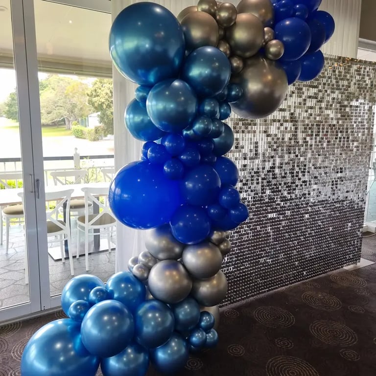 Silver shimmer wall with blue and silver garland for Bev's 70th birthday in Wynnum, Brisbane.