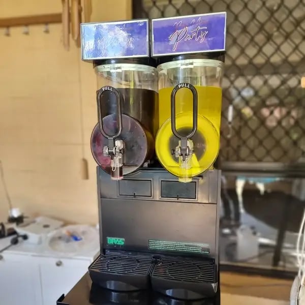 Slushie machine in place for Rhys's 21st, barrels full and making ice cold slushie before guests arrive.