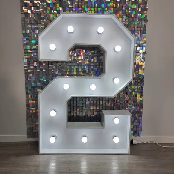 White two marquee number in front of an iridescent shimmer wall in Redland Bay.