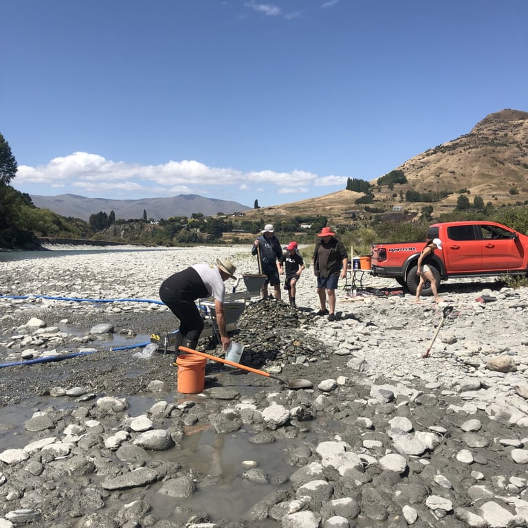 A photograph of a group of people, sluicing for gold on a river in Central Otago, New Zealand.
