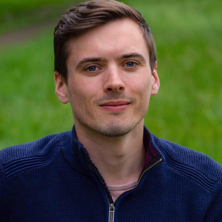 a man with a blue jacket and a white shirt
