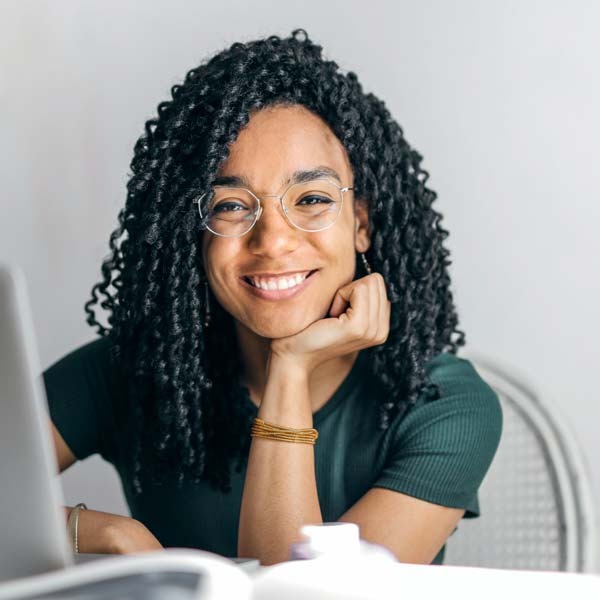 Pleased female patient near laptop computer