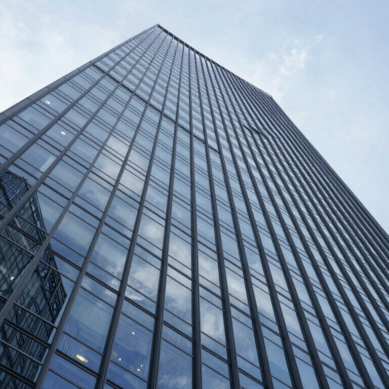 A wide shot of a sleek modern boardroom with deep charcoal teal leather chairs and soft ice minimalist walls.