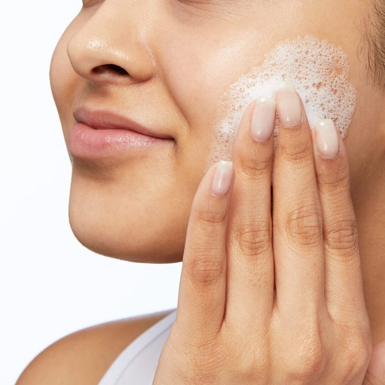 Woman washing face with natural chamomile facial cleanser