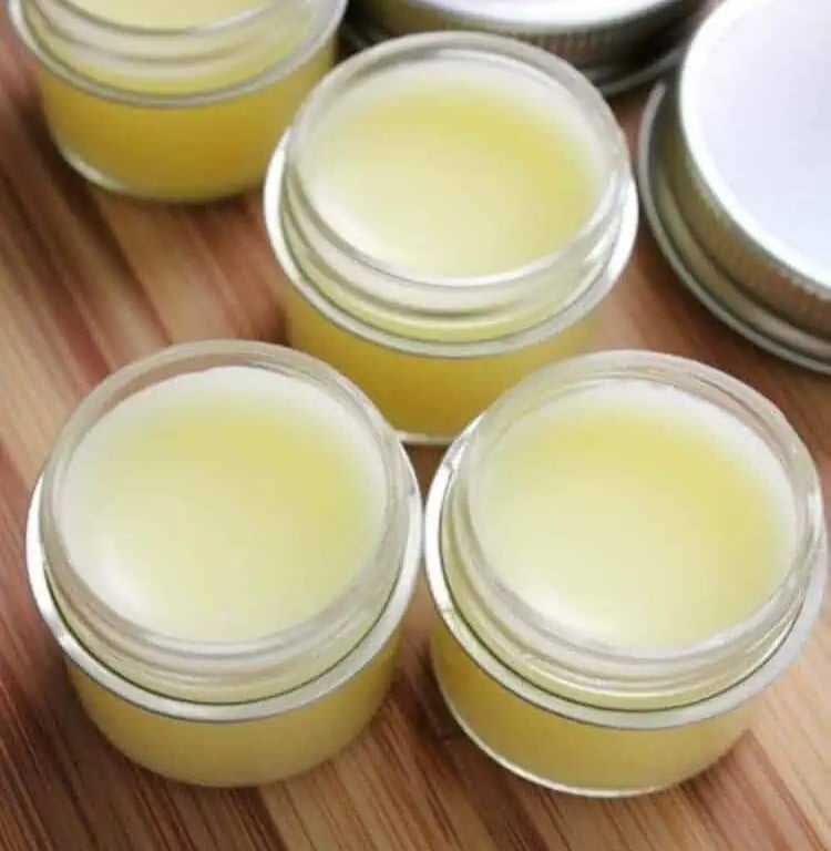 ngredients for DIY papaya lip balm recipe on wooden surface