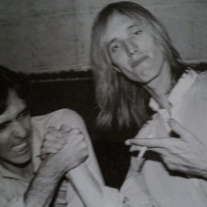 Charlie Kendall arm wrestling with Tom Petty.