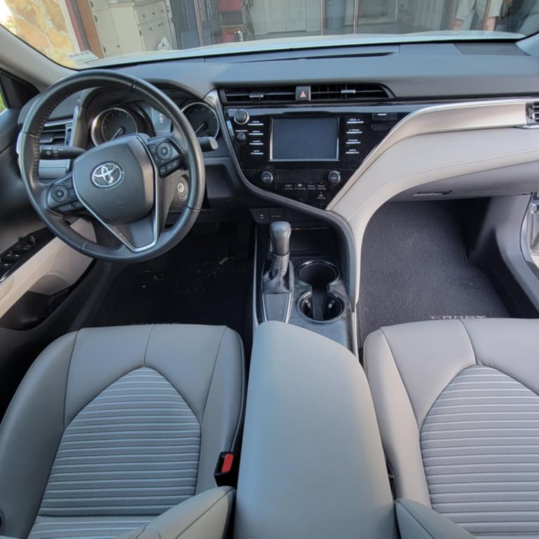 The interior light gray of a toyota camry after a mobile detailing service