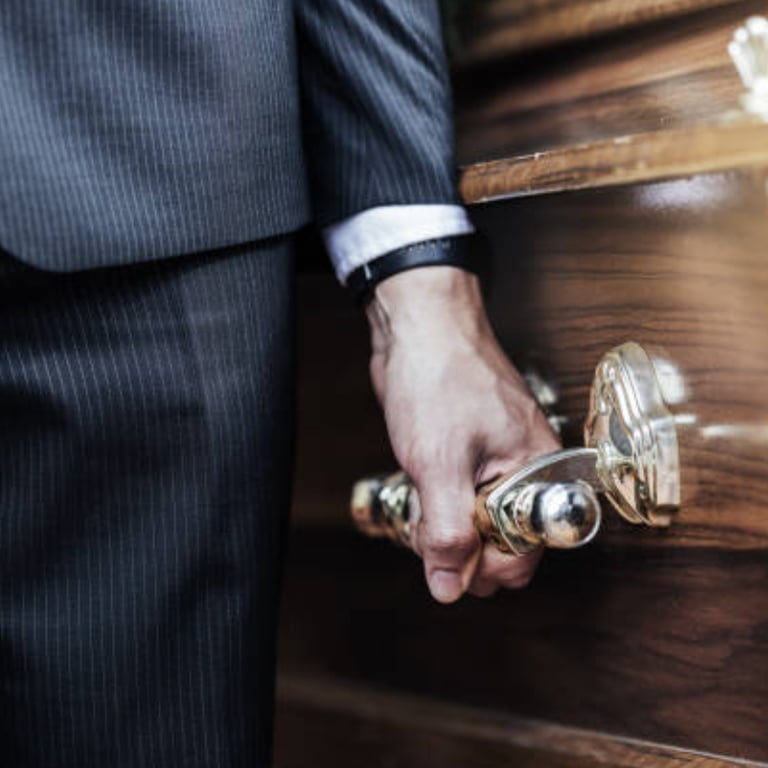 a close up of a pall bearer holding a coffin's handle