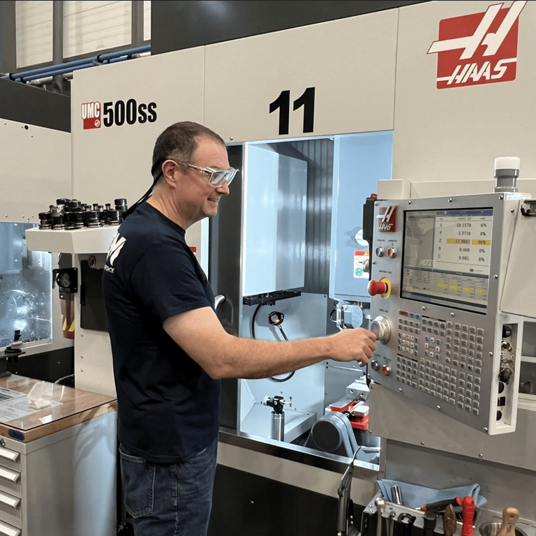 Photo is of a man working at a machine