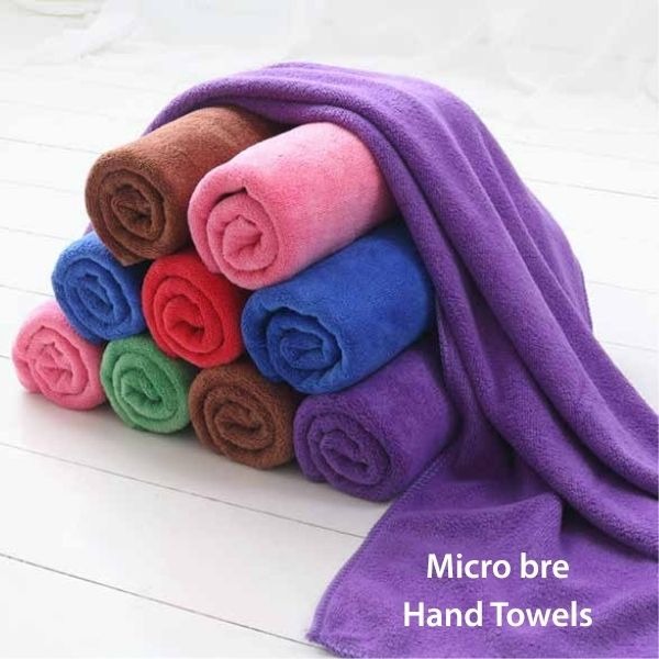 a pile of Micro Bre hand towels on a white floor