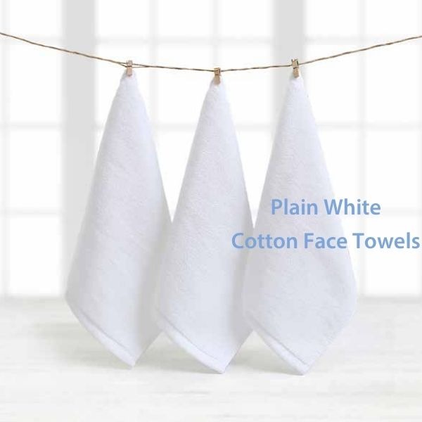 three white cotton face towels hanging on a clothes line