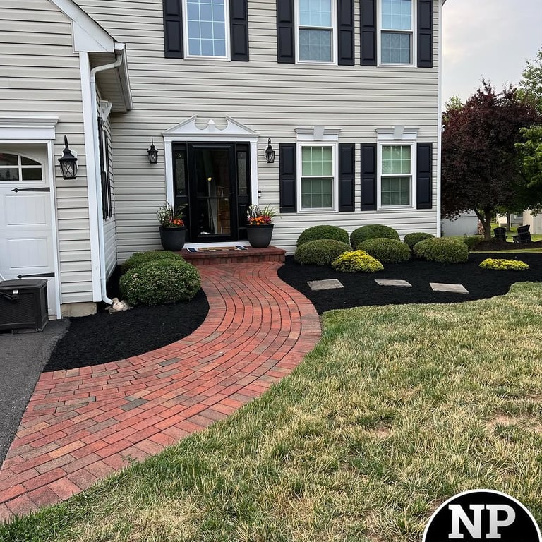 excellent landscaping and hardscaping of grass, stones and trees by NP Landscaping