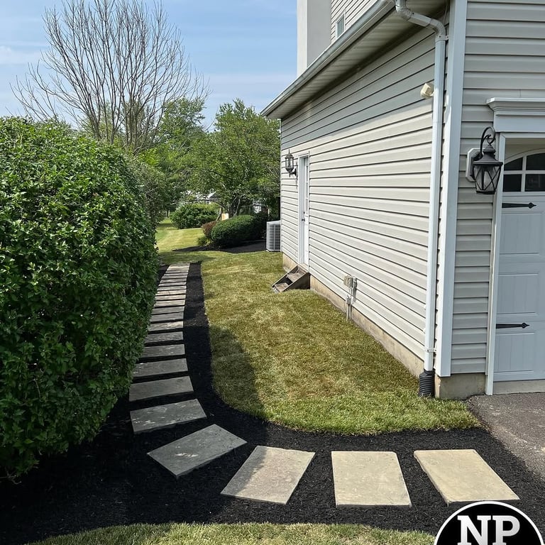 excellent landscaping and hardscaping of grass, stones and trees by NP Landscaping