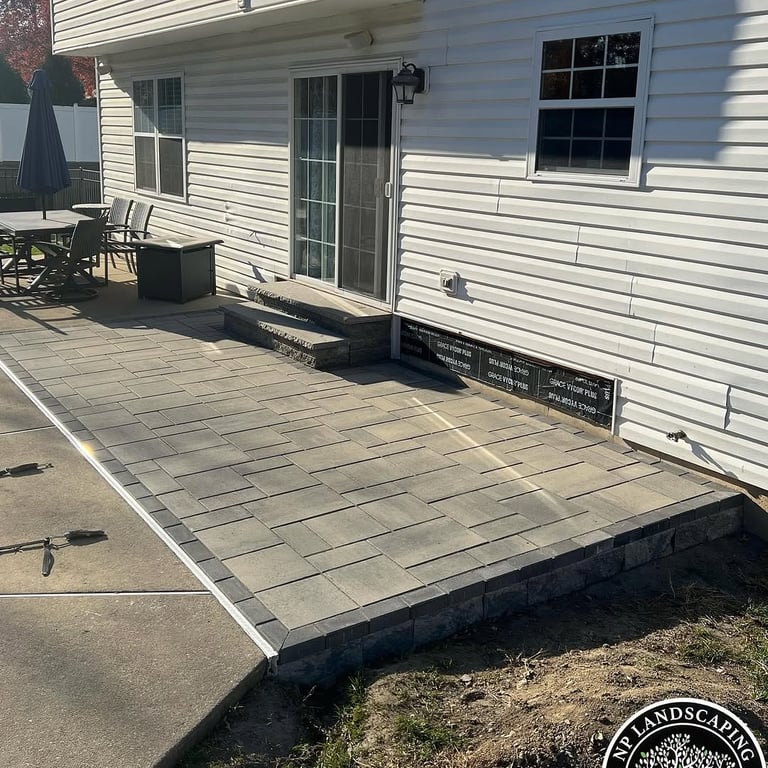 excellent landscaping and hardscaping of grass, stones and trees by NP Landscaping