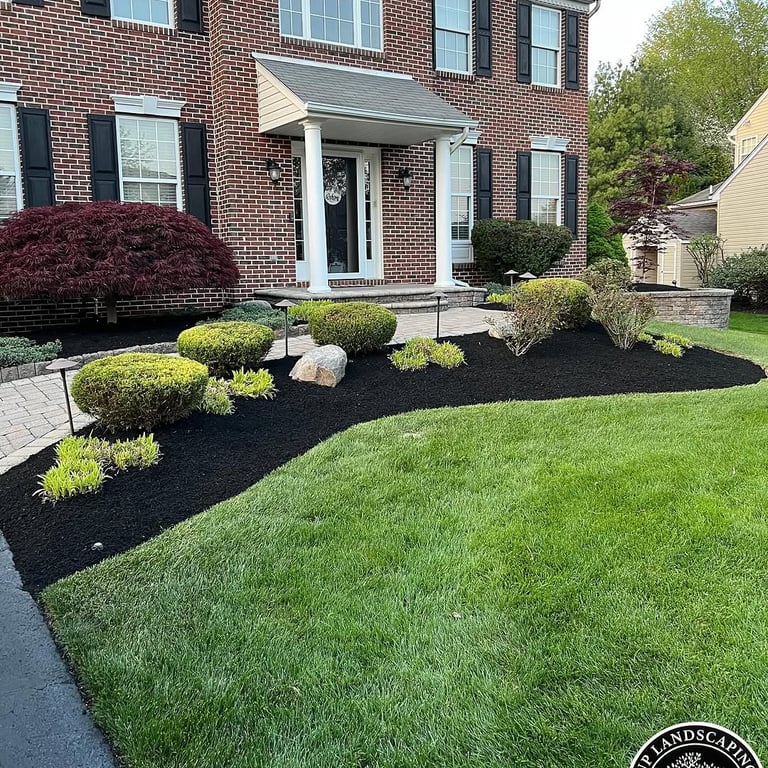 excellent landscaping and hardscaping of grass, stones and trees by NP Landscaping