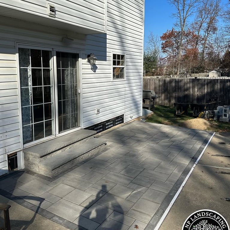 excellent landscaping and hardscaping of grass, stones and trees by NP Landscaping