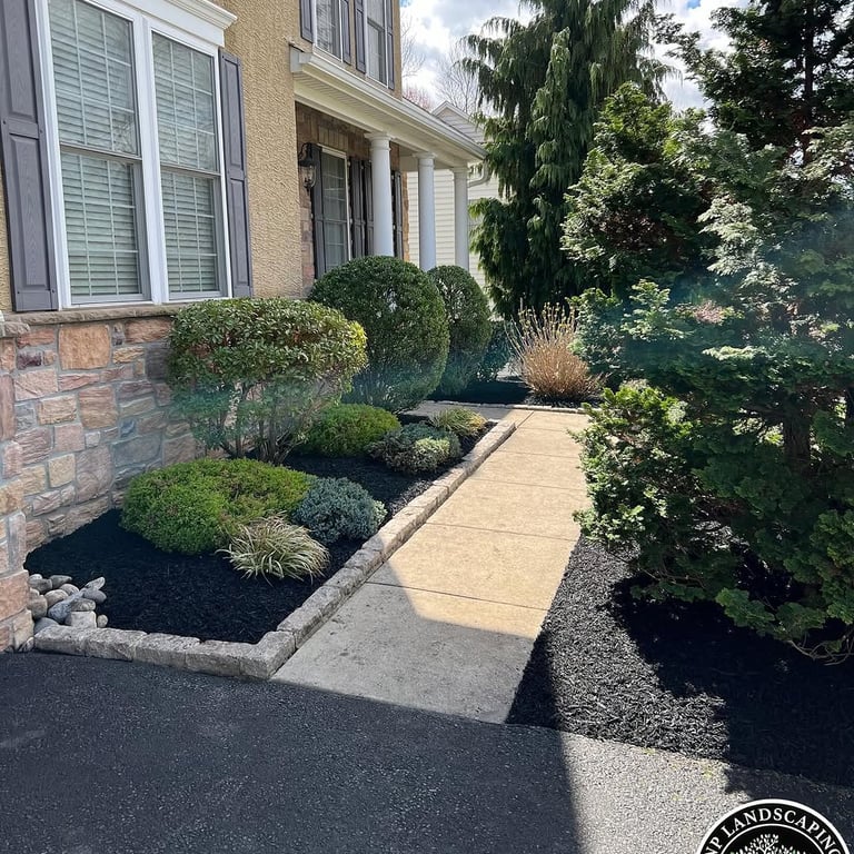 excellent landscaping and hardscaping of grass, stones and trees by NP Landscaping