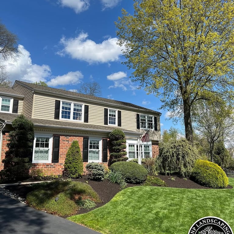 excellent landscaping and hardscaping of grass, stones and trees by NP Landscaping