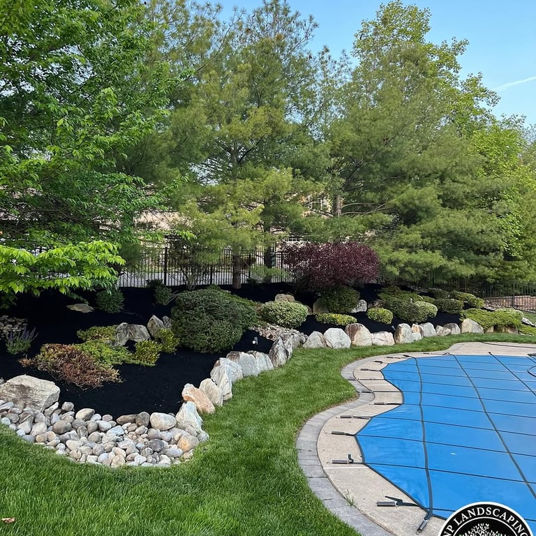 excellent landscaping and hardscaping of grass, stones and trees by NP Landscaping