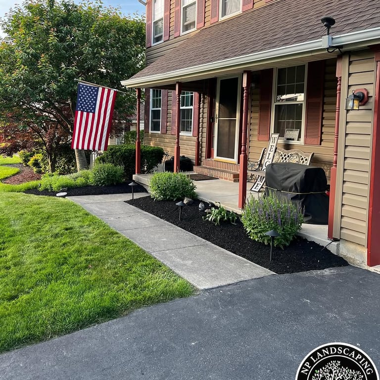 excellent landscaping and hardscaping of grass, stones and trees by NP Landscaping