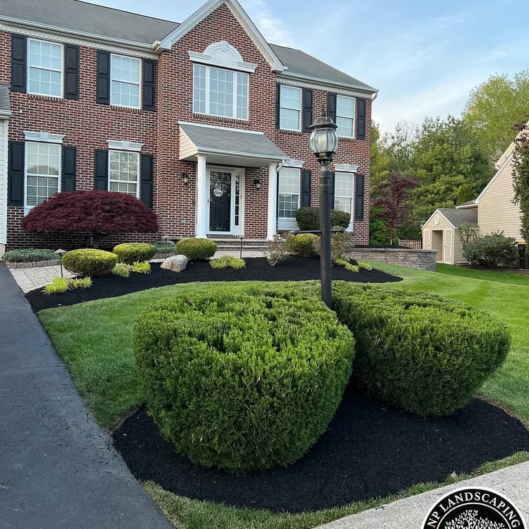 excellent landscaping and hardscaping of grass, stones and trees by NP Landscaping