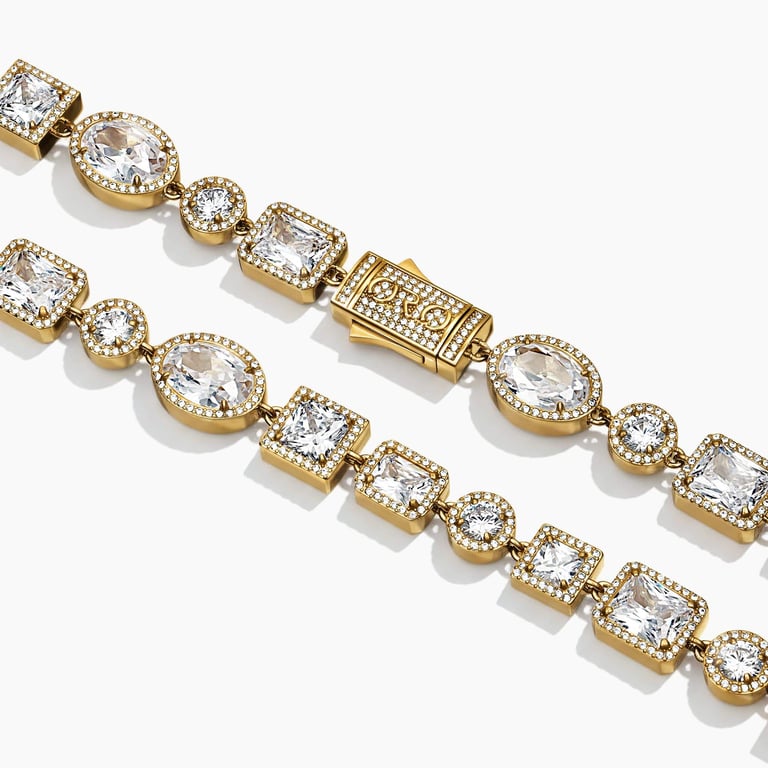 Close-up studio shot of a gold tennis bracelet featuring alternating oval and square cubic zirconia stones.
