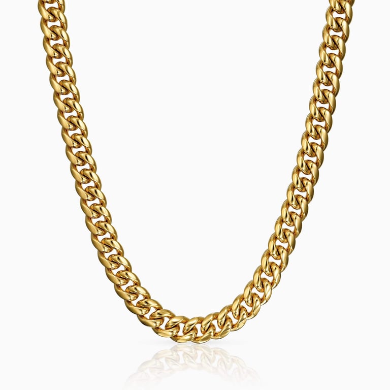 Studio photo of a 12mm thick gold Cuban link chain hanging and reflecting on a white surface.