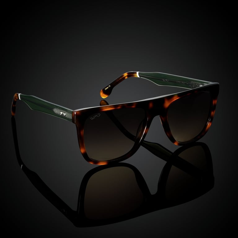 Tortoiseshell sunglasses with green accents and brown lenses, displayed on a reflective black background for e-commerce photo