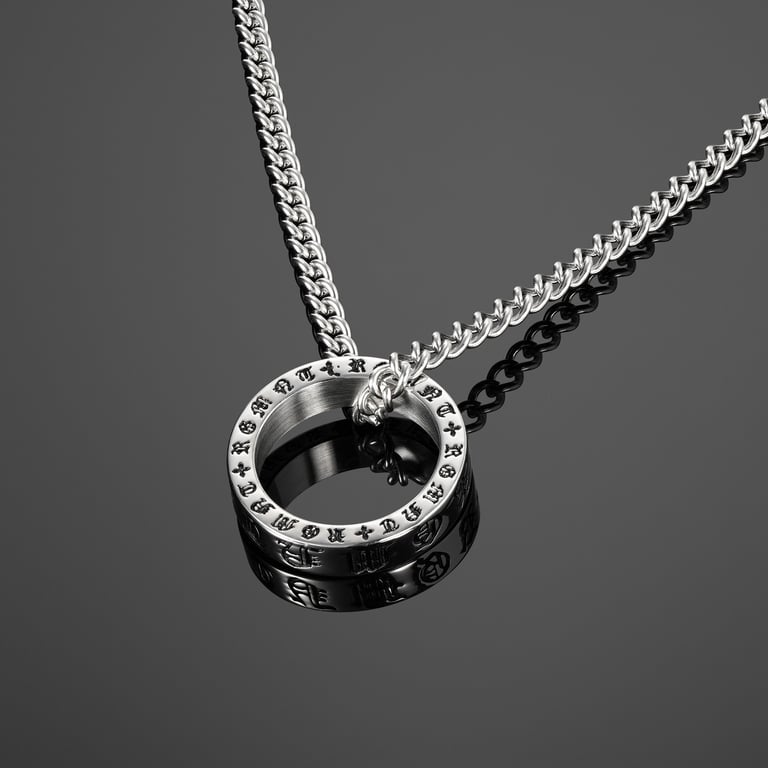 Sleek silver necklace with a circular pendant featuring intricate engraved symbols, showcased on a dark reflective background