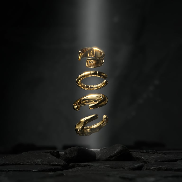 Four elegant gold ear cuffs floating above a dark stone base, illuminated against a black background for e-commerce photo
