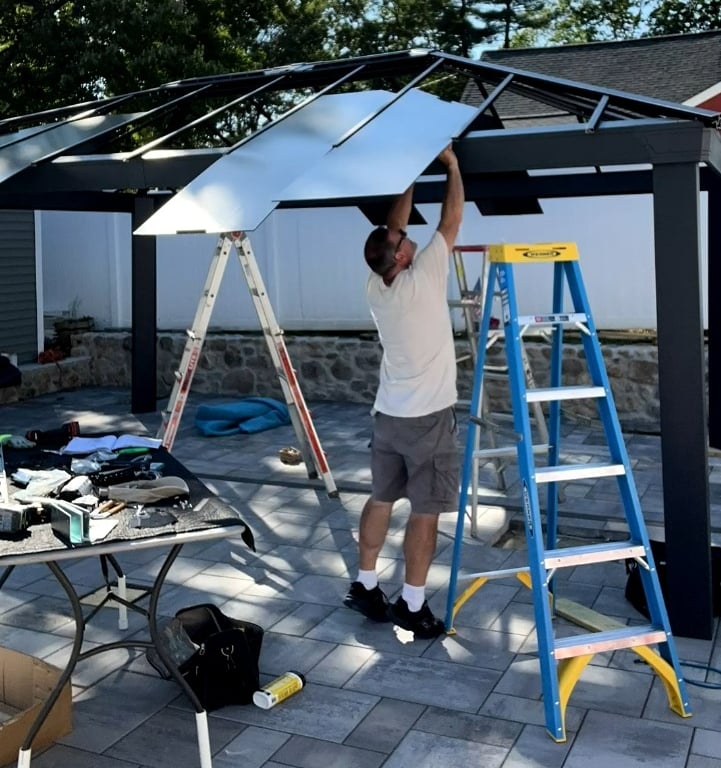 Polycarbonate roof panels being installed on a Canopia gazebo in Billerica, MA
