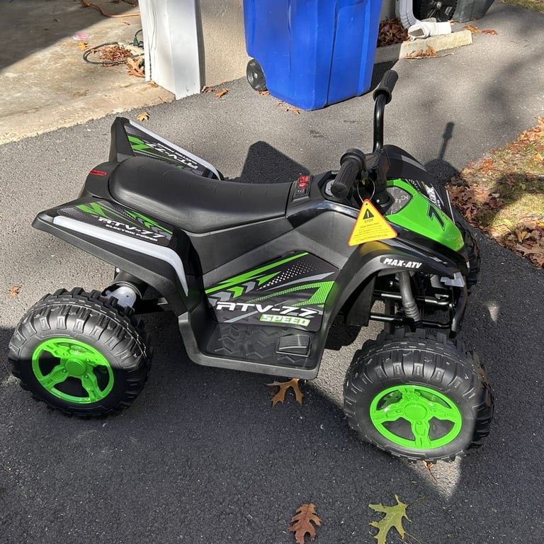 side view of assembled kid's ATV 4-wheeler by Leisrideon, battery operated, green