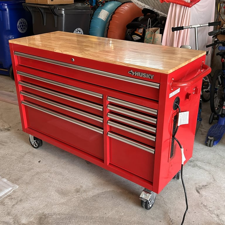 Partially assembled Husky rolling workbench showing handle and power cord