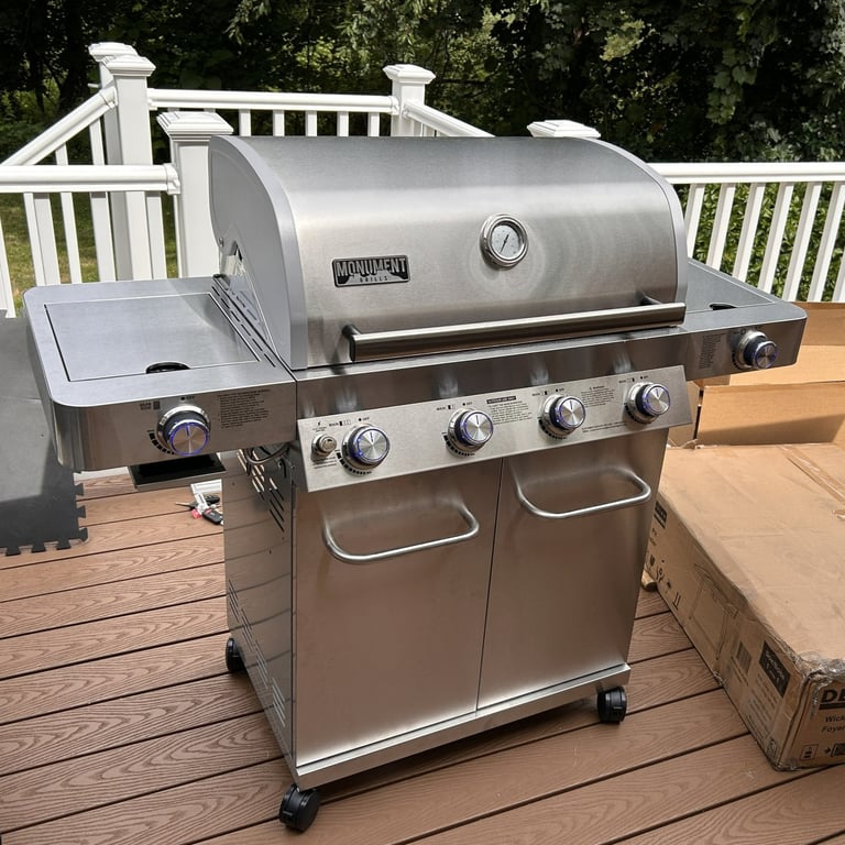 A Monuments gas grill assembled for a client in Methuen, MA. Stainless steel 4-burner with dual side burners.
