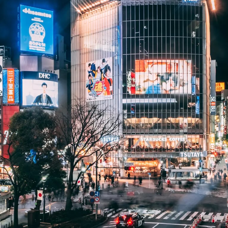 View of Shibuya Crossing at night with neon lights and pedestrians – iconic Tokyo travel guide image