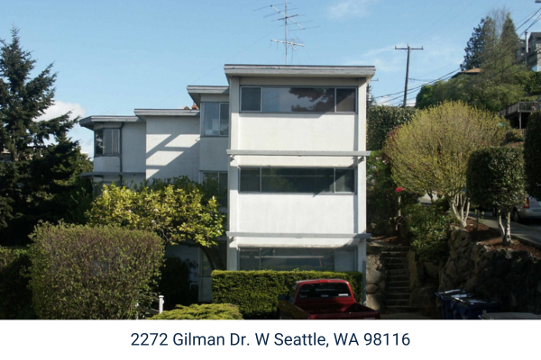 A multi-family apartment building with white experior.